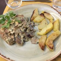 Seitan escalopes with mushroom sauce and potato wedges. at Rifugio Romano in Rome