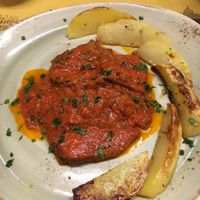 Seitan escalopes with tomato (pizza) sauce and potato wedges. at Rifugio Romano in Rome
