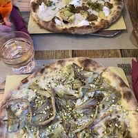 Pizza with Broccoli, vegan sausage and vegan mozzarella & Pizza with artichokes and pistachios   at Rifugio Romano in Rome