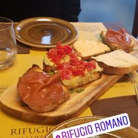 mixed Bruschetta plate with hummus, different spreads and vegan ham, it was amazing! at Rifugio Romano in Rome