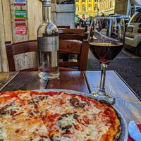 Diavola pizza with a glass of vegan Piceno Ciu Ciu. at Rifugio Romano in Rome