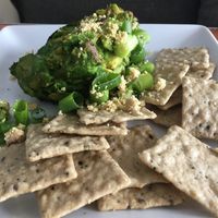 Smokey avocado dip with cashew cheese crumbles and rice crackers! at Cafe Wylde in Everett