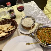 Chana Masala, garlic naan, side of rice, and black currant juice  at Indian Raja in Riga
