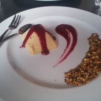 Peach semi-freddo with raspberry sauce and toasted nuts at Mia in Modena