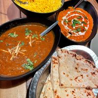 Yellow rice, butter chick’n, dal makhani, cheezy garlic naan 🤤  at Temple of Spices in Mermaid Beach