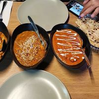Chicken Korma, Chicken Madras, and Butter Chicken. Got a rice and Cheese and Garlic Naan. Drink was Mango Lassi at Temple of Spices in Mermaid Beach