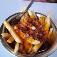 Papas con cheddar y tocino (bacon and cheddar) at Comet 984 in Playa Del Carmen