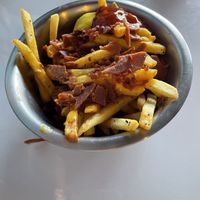 French fries with cheese and vacon   at Comet 984 in Playa Del Carmen