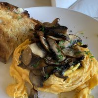 Scrambled egg, topped with portobello mushroom cooked in garlic butter, along with two slices of sourdough!  at Buhler & Co in East London