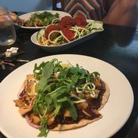 Pizza in the foreground with eggplant meatballs in the background at goodbeet in Haddon Township