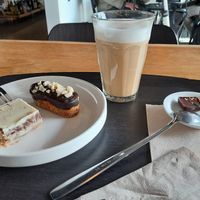 Latte with oat milk and 2 chocolate pastries (white chocolate and peanut) at Noordoever in Leuven