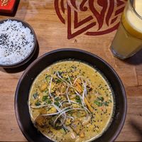 Red coconut curry, rice and passion fruit juice. at The Vegan Temple by Prasada in Cusco