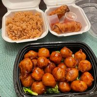 Orange chicken with side of fried rice and egg rolls at Veggie Express in Frisco