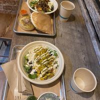 Shawarma bowl (top) with hummus, za'atar cauliflower (bottom) with kale salad at Shouk in Washington
