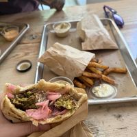Fancy falafel in a pita with spice fries and shouk saucee  at Shouk in Washington