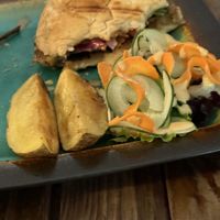 Partially eaten burger with potato wedges.    at Kind Earth Eatery in Dar Es Salaam