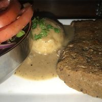 Seitan fillet with broccoli, mashed potatoes and gravy, and a side salad  at Graze in Nashville