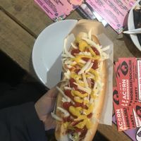 The vegan hotdog. It was not prepared it was supposed to be because the place was so busy. You can see the cheese was not melted and the veggies were raw in it at 3 Three's Coffee Lounge in Birmingham