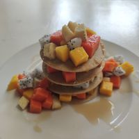 Vegan banana pancakes with tropical fruits and coconut caramel at Greenlight Cafe & Bar in Koh Samui