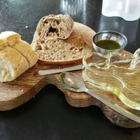 The wonderful assortment of breads I was served before my main course. The server who brought it to me initially served the bread with a dish of butter, but the one who had taken my main course order quickly realised this, came to my table and asked if I was vegan. When I confirmed, he graciously took away the butter and returned with accompaniments that were, in my opinion, far better than any non-dairy butter: olive oil, salt and fresh, local herbs. Yum! at Aalto Bistro in Reykjavik