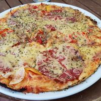 Vegan pizza with 'sausages' and 'cheese' at Punkt 13:15 in Parnu