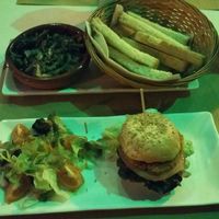 Mushrooms served with toasted bread and a mini burger with salad. at Green Iguana Bar in Malaga
