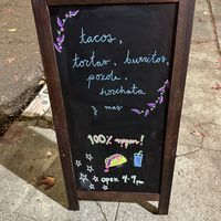 Sign out front  at Taqueria La Venganza in Oakland