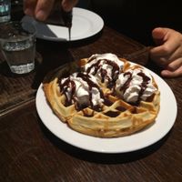 Waffle with chocolate sauce and whipped cream at Janine Loves Sunday in Paris
