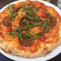 Chorizo pizza with “chorizo,” cherry tomatoes, basil, and pesto! Best pizza I’ve ever had. House-made cheese.  at Janine Loves Sunday in Paris