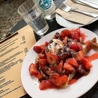 vegan spelt waffle with strawberries, vegan vanilla ice cream, strawberry and chocolate sauce at Cafe Neue Liebe in Berlin