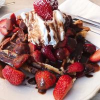 Vegan Belgian waffles with chocolate sauce and strawberries at Cafe Neue Liebe in Berlin