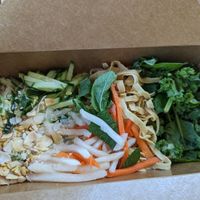Salads are nicely boxed for transport with dressing on the side at Chau VeggiExpress - Granville Island Stall in Vancouver