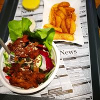 sides: fries and salad with faux-meat ontop  at Farma Burgerownia Roslinna in Krakow