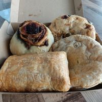 Clockwise from top Steak & Pepper pie, Chickn Pie, Sausage Roll, Cheesymite Scroll. at Veganyumm Bakehouse in Brisbane