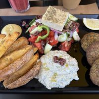 The Veganaki special, with mung bean patties, salad, homemade tzatziki, and air fried potatoes  at Veganaki in Athens