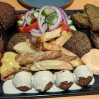 Mix Grill (for 2 persons) -variety of patties and skewers: 2 mung bean patties, 2 soy 
souvlaki skewers, 2 tempeh souvlaki skewers, 4 falafel, 1 green lentil patty, and 1 vegeta at Veganaki in Athens