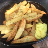 Oven baked chips with mustard mayo at Veganaki in Athens