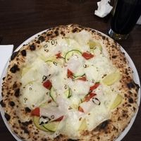 Pizza with potatos, bell peppers, zucchini and vegan cheese at La Stella Nera in Berlin
