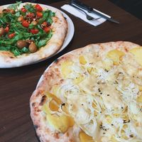 potato and onion white pizza, arugula green pizza (2016) at La Stella Nera in Berlin