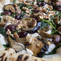 Spinach pizza with extra toppings   at La Stella Nera in Berlin