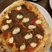 Pizza with spicy sauce and homemade cheesee  at La Stella Nera in Berlin
