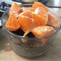 Chia pudding with banana topped with chocolate and tangerine at Joe's Place in Pico