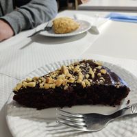Chocolate and peanut cake, scone in the background at Veganeats Caffe in Lisbon