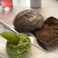 Bread with freshly chopped avocado & a slice of lime at Veganeats Caffe in Lisbon