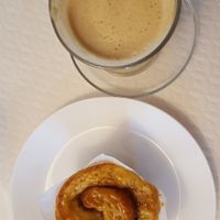 Cafe latte and cinnamon cake at Veganeats Caffe in Lisbon