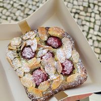Matcha raspberry and almonds brioche at Veganeats Caffe in Lisbon