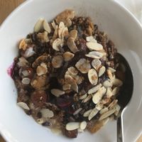 oatmeal w/ granola, pieces of chocolate, nuts etc  at Oatmeal in Paris
