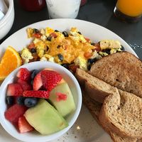 My breakfast entree called Woods Tofu from the menu. It's was tofu with black beans and tomatoes with vegan cheese and fresh fruit! We had fresh squeezed orange juice and frozen lemonade because it was so humid. Then even have a vegan milkshake menu. I was impressed with all the vegan entrees!!!! at Crazy Burger in Narragansett
