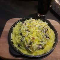 Mashed potatoes with mushrooms, beans, onions, and covered with vegan cheese at Eesti Pubi Ruuni in Tartu