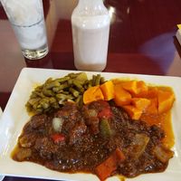 Gluten jerk, sweet potatoes, green beans, and peanut punch. at Jamaicaway in Nashville